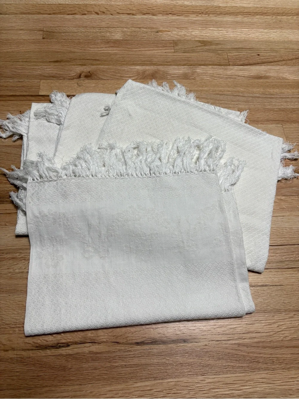 Textured off-white woven vintage towel set featuring decorative knotted fringe